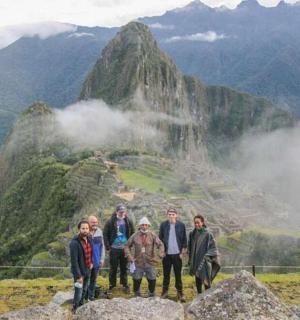 a group of people standing on top of a mountain