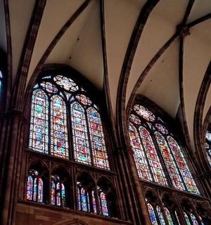 two large stained glass windows in a church