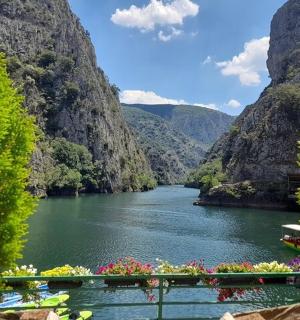 a boat in a river between two mountains