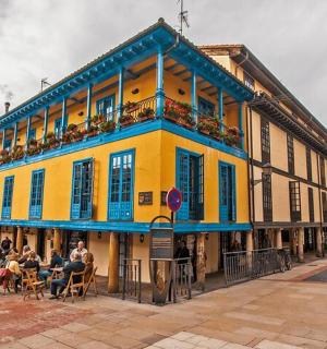 a yellow and blue building on a city street
