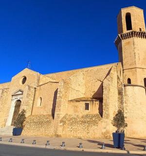 a large stone church with a tower on a street