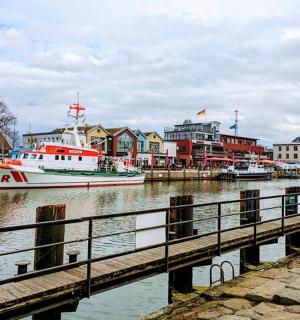 a boat is docked next to a dock with buildings