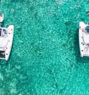 two boats are docked in the blue water