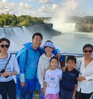 skupina lidí stojící před vodopádem