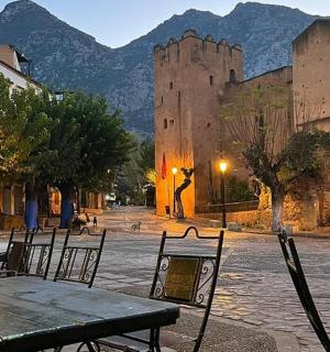 a table and chairs in front of a castle