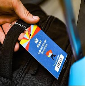 a person holding a tag on a bag