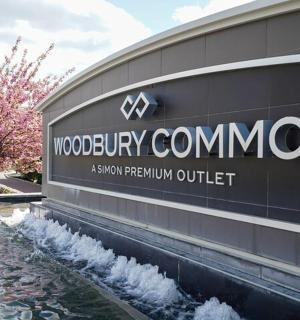 a sign on the side of a building with a fountain