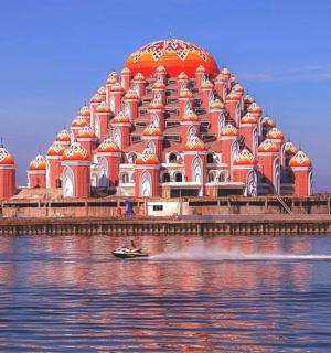 a building on the water with a boat in the water