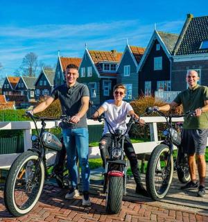 a group of three people with their bikes on a bridge