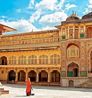 a woman standing in front of a large building