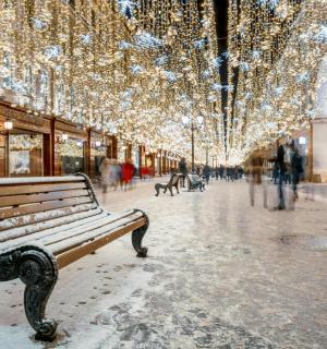 a bench on a city street with christmas lights