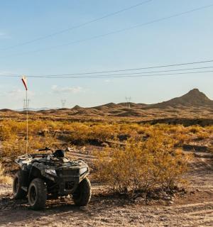 an atv on a dirt road in the desert