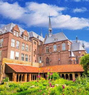 a large brick building with a spire on top of it