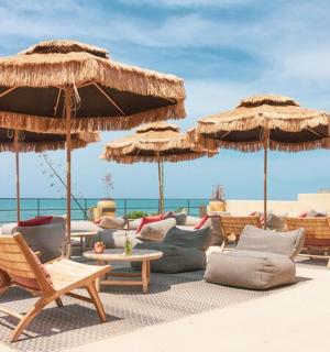 a group of chairs and umbrellas on the beach