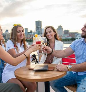 a group of people sitting around a table drinking champagne