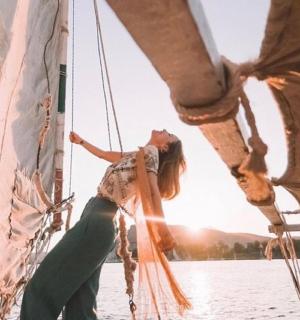 一名女子在水中的帆船上