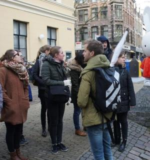 a group of people standing next to a statue