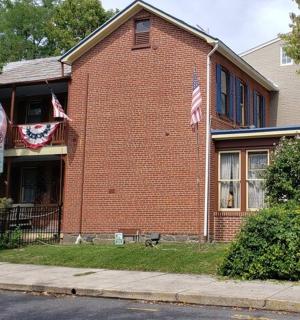 a brick building with american flags on the side of it