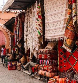 a market with many different types of carpets on display