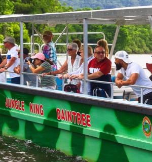 a group of people on a green boat in the water