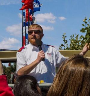 a man holding an american flag in a crowd of people