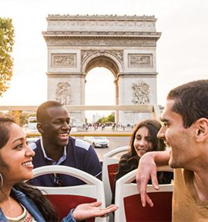 a group of people riding on a bus in front of the monument