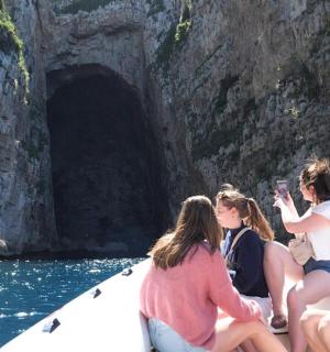 a group of people sitting on a boat in the water