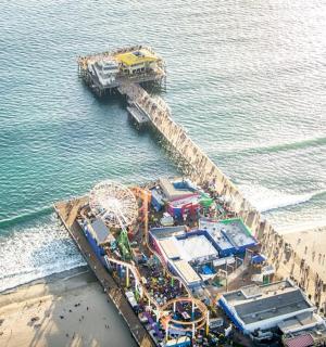 an aerial view of a pier next to the beach