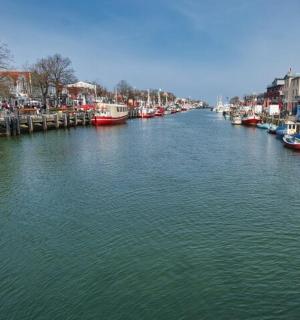 a river with many boats docked in a city