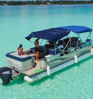 a group of people sitting on a boat in the water