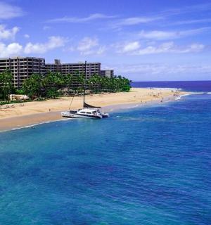 a boat in the water next to a beach