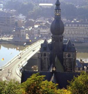 a large building with a clock tower and a bridge