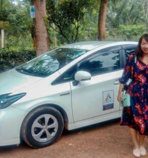 a man and a woman standing next to a white car
