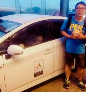 a man and a woman standing next to a car