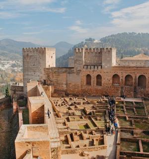 a view of a castle with a city in the background