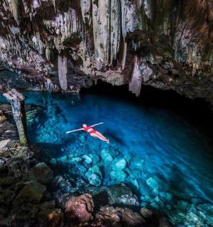 a person in a kayak in the water in a cave