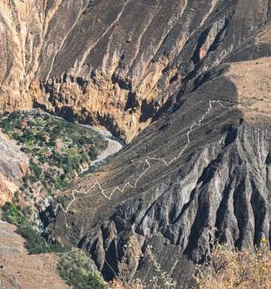 an aerial view of a mountain with a river