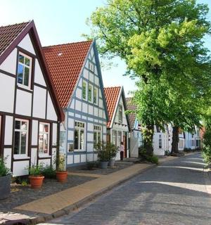 a street in a town with white and blue houses