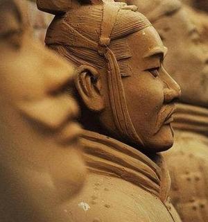 a statue of a woman sitting next to other statues