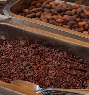 two trays filled with nuts and a spoon