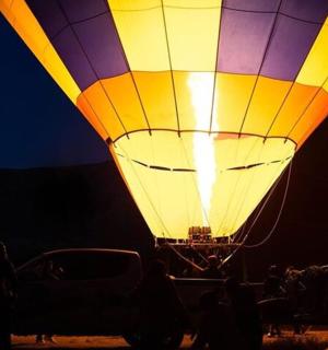a large hot air balloon lit up at night