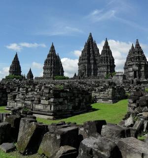 a group of stone buildings in a field