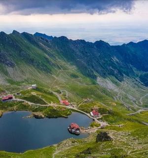 an aerial view of a mountain with a lake