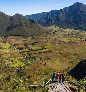 a group of people standing on top of a mountain