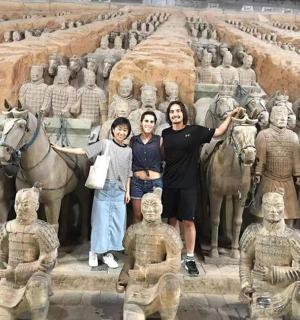 a group of people standing in front of a statue