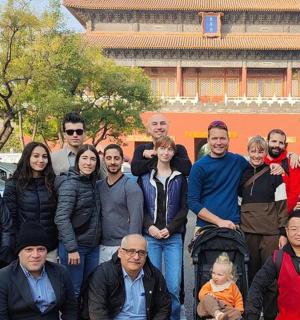 a group of people posing for a picture in front of a building