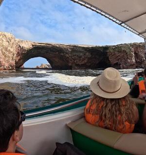 a group of people on a boat looking at a bridge