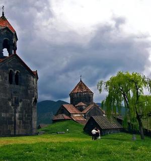 two people standing in front of an old church