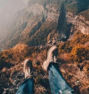 a person with their feet up on a mountain