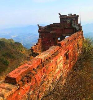 an old building on the top of a mountain